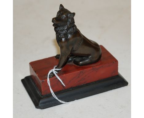 A bronzed figure of a seated wolf on a marble plinth, h.10cm