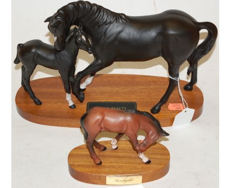 A Beswick Connoisseur Model Black Beauty & Foal, black matt finish, on wooden plinth; together with one other Beswick horse '