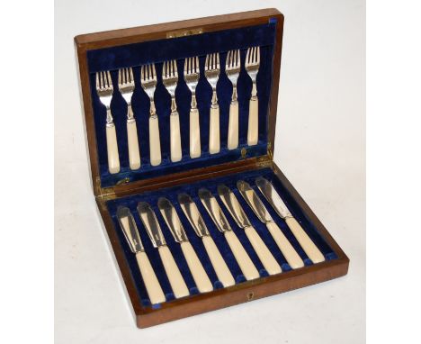 An early 20th century oak cased eight place setting of silver plated fish cutlery; together with various mother of pearl hand
