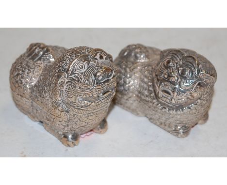 A pair of early 20th century Chinese white metal trinket jars and covers, each in the form of a Gou dog, stamped 800 verso
