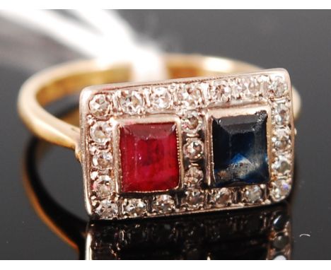An Art Deco yellow metal (tests as 18ct), ruby, sapphire and diamond ring, arranged as twin illusion set square cut ruby and 