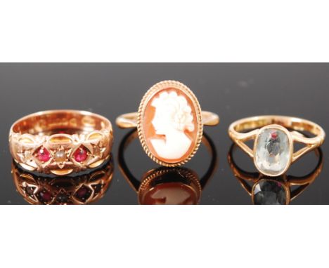 A 9ct gold ruby and seed pearl set ring, size Q, together with a 9ct gold carved shell cameo set ring, and an 18ct gold aquam
