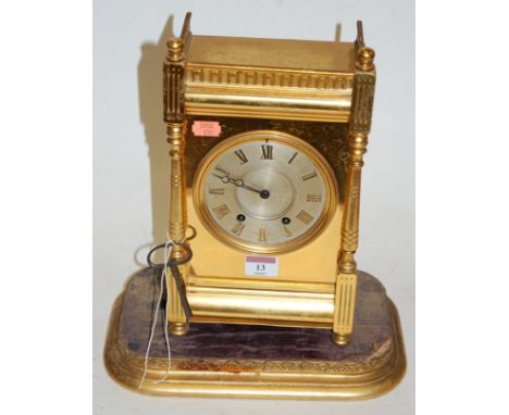 A late 19th century French brass cased mantel clock, having pierced gallery, silvered dial with Roman numerals, and eight day