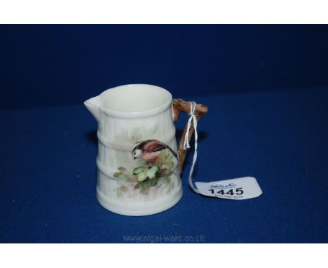 A small Royal Worcester Jug painted with a Longtail Tit, signed N. Powell, (small chip to spout)  2 1/2'' tall
