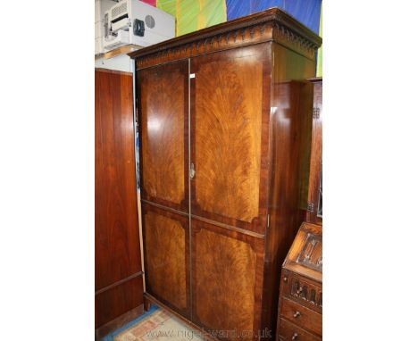 A good reproduction Mahogany Georgian style double door Wardrobe having moulded castellated cornice with moulded corbel style