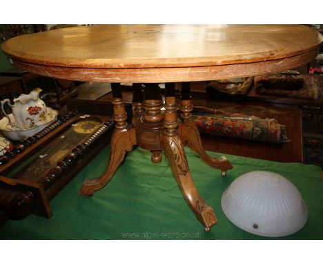 A 19th c. light Walnut oval looe Table, inlaid snap top with central motif, standing on five column pedestal base with four s