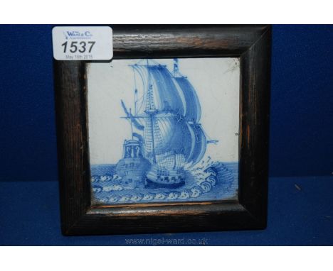 A good antique Delft tile painted in blue with a galleon in full sail.  17th - 18th century.  Framed