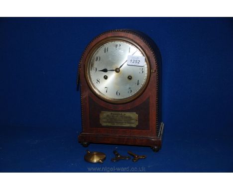 A Dome shaped Mahogany cased two train movement Mantle Clock.