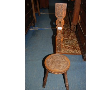 A three legged Spinning Chair with Celtic style carved decoration