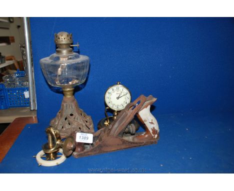 A Victorian Oil Lamp with cast base, glass reservoir, a German anniversary Clock a/f, a brass Nut Cracker in the form of a sh