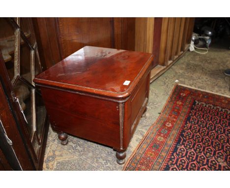 A Victorian flame Mahogany Commode, having moulded edge well figured lid, single panel front, plain sides, on turned legs.  2