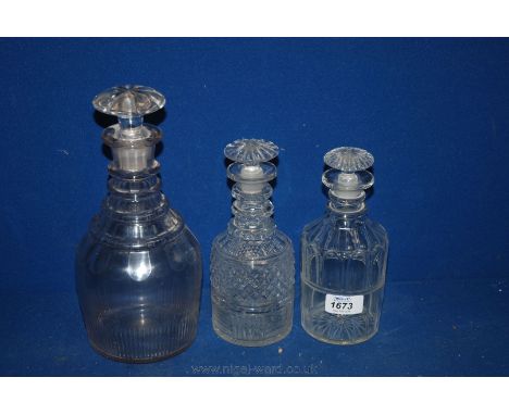 One large and two small ring neck Decanters, the larger with thumb cut decoration and all with mushroom shape stoppers.