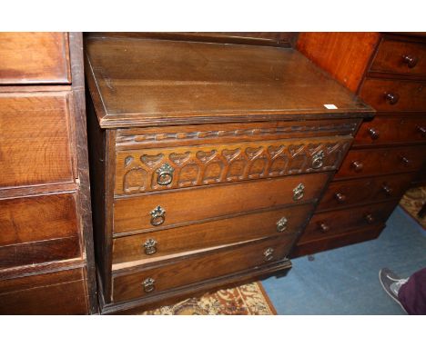A reproduction Oak chest of Drawers, upstand back, applied moulded edge to the top, carved frieze, flight of four drawers, th