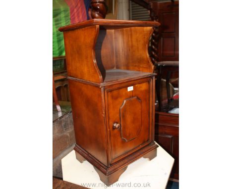 A reproduction light Mahogany finished bedside Cabinet, moulded rectangular top over open compartment, over lower single pane