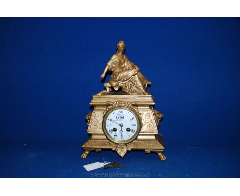 A Gilded Mantle Clock with reposing classic lady and with key.