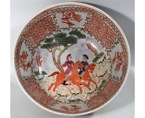 An Oriental Bowl in Famille Vert colours and decorated with a European style hunting scene, six figure mark to the base in re