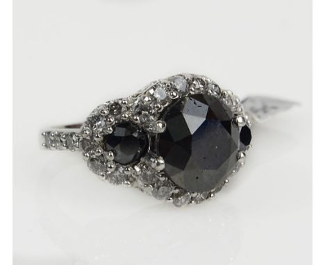 AIG Certified 7.48 Carat Fancy Black Diamond Three Stone Ring Accented Throughout with White Diamonds Set in 14 Karat White G