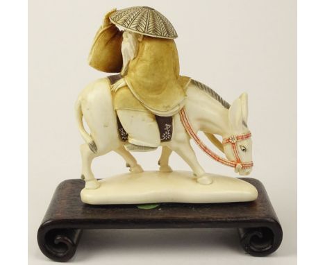 19/20th Century Chinese Carved and Polychromed Ivory Figurine, Depicting Zhang Guo Lao, The Eldest Immortal Riding Backwards 