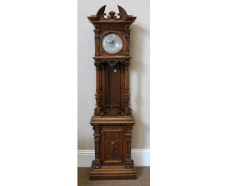 A German Carved Oak Striking Longcase Clock, circa 1880, broken arch form pediment with three turned finials, trunk with flut