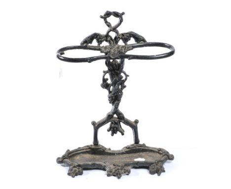 A Victorian Black Cast Iron Stick Stand, late 19th century, decorated with vines with a serpentine shaped drip tray and cast 