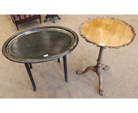 A George III Mahogany Fliptop Tripod Table, early 19th century, with moulded pie crust border raised on a gun barrel baluster