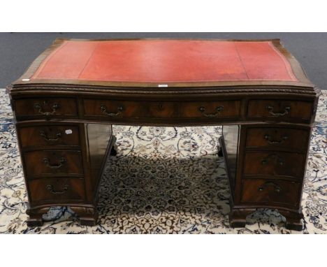 A Mahogany Chippendale Style Serpentine Shaped Double Pedestal Desk, 20th century, with inset red and gilt leather writing su