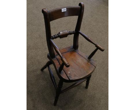 A Child's Beech and Elm Windsor Commode Armchair, late 19th century, with spindle arm supports above a hinged seat, raised on