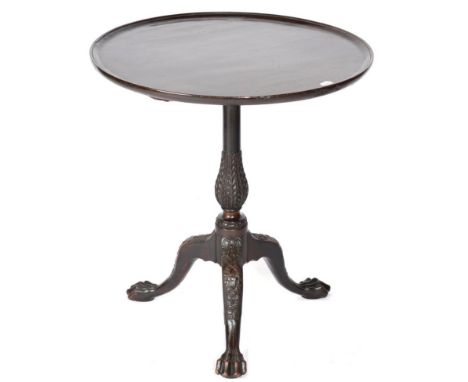 A Mahogany Fliptop Tripod Table, the associated moulded top raised on a carved baluster support with three cabriole legs and 