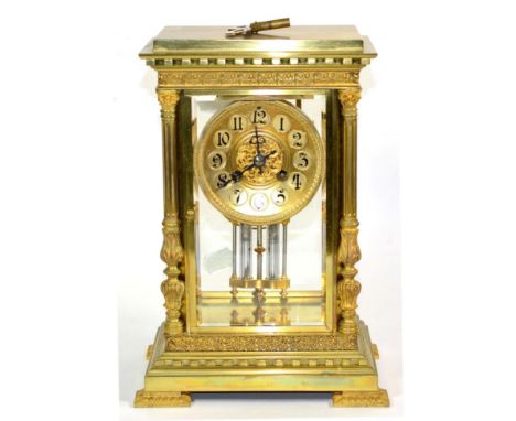 A Brass Four Glass Striking Mantel Clock, circa 1900, Corinthian columns, bevelled panels, 3-1/2-inch dial with Arabic numera
