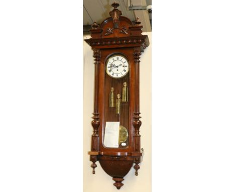 A Vienna Type Quarter Striking Wall Clock, circa 1890, arched pediment, glazed trunk door and side windows, 6-1/2-inch enamel