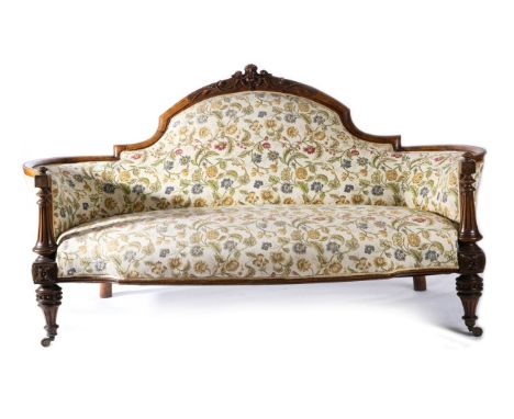 A Victorian Walnut Framed Sofa, circa 1870, recovered in floral fabric with padded back support, rounded arms and overstuffed