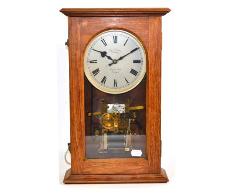 A Synchronome Electric Wall Clock, retailed by Dykes Bros, Glasgow, circa 1930, rectangular form oak case with a glazed front