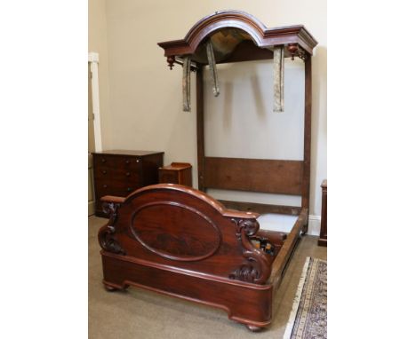 A Victorian Carved Mahogany Half Tester Bed, mid 19th century, with a moulded canopy top above inverted turned finials, with 