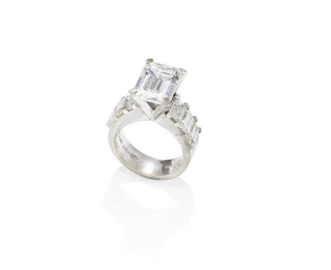DIAMOND RINGThe step-cut diamond, weighing 3.95 carats, between baguette-cut diamond-set shoulders, in a brushed mount, remai