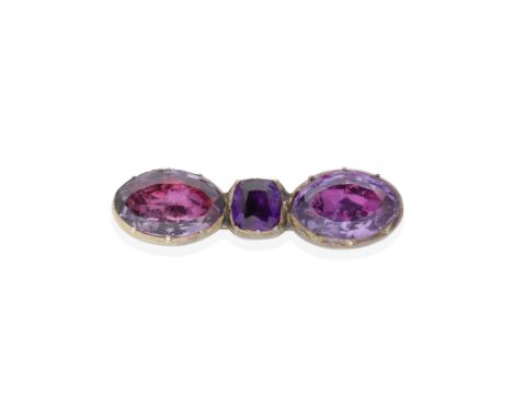 AMETHYST BROOCH, 19TH CENTURYComposed of three vari-cut foiled amethysts in closed-back settings, length 3.2cmFootnotes:Prove