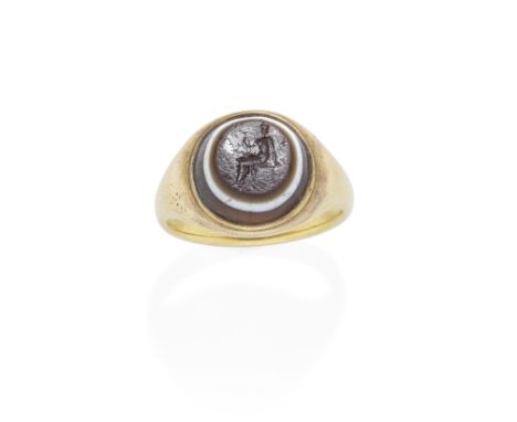 PASTE INGAGLIO RING, 19TH CENTURYThe paste stone resembling banded agate depicting a seated female figure, possibly the Godde