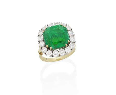 EMERALD AND DIAMOND RINGThe step-cut emerald, weighing 6.92 carats, within a surround of 16 brilliant-cut diamonds, diamonds 