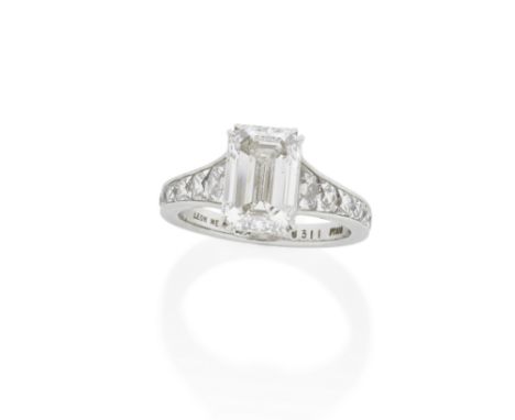 LEON MEGÉ: DIAMOND RINGThe step-cut diamond, weighing 3.11 carats, between shoulders channel-set with graduating French-cut d