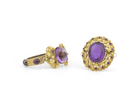 AMETHYST BROOCH AND BRACELET SUITE, CIRCA 1830The bracelet, set to the centre with a sugarloaf amethyst, to an openwork fine 