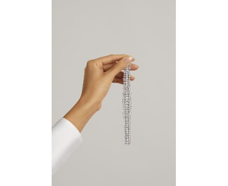 DIAMOND BRACELETThe flexible tapering strap set with a graduated series of step-cut diamonds, between graduated rows of brill