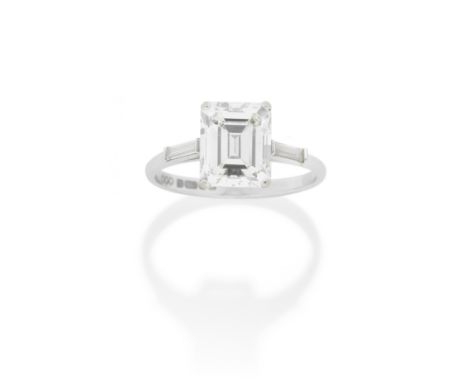 DIAMOND SINGLE-STONE RINGThe step-cut diamond, weighing 3.11 carats, between baguette-cut diamond shoulders, mounted in 18 ca