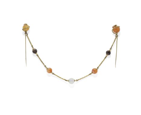HARDSTONE ORNAMENTAL CLASP, 19TH CENTURYComposed of two stickpins, each spherical carnelian bead terminal with twining serpen