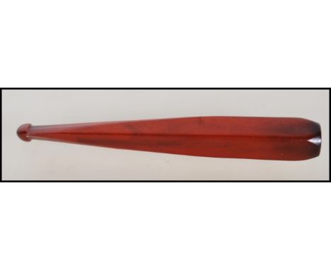 A vintage early 20th Century Art Deco bakelite cigarette cheroot holder being red in colour. Measures 10cm. Weight 10g.&nbsp;