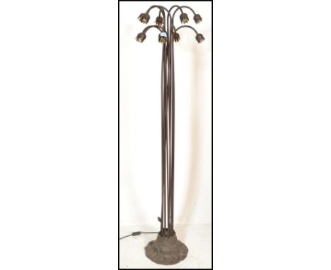 A 20th century multi branch metal multi flower upright floor standard lamp. Each tubular metal stem rising from a naturalisti