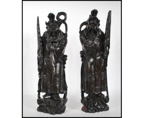 A pair of 20th century Chinese carved hardwood figures of Deity's / Immortals raised on a naturalistic base with silver wire 