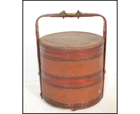 A vintage 20th Century Chinese bamboo woven&nbsp;lacquered and brass bound wedding food storage pot, carry handle to the top