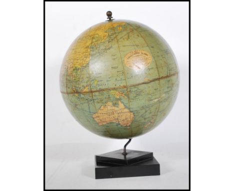 A vintage 1930's Art Deco desk top Philip's Challenge globe, the map depicting shipping routes and transcontinental railways,