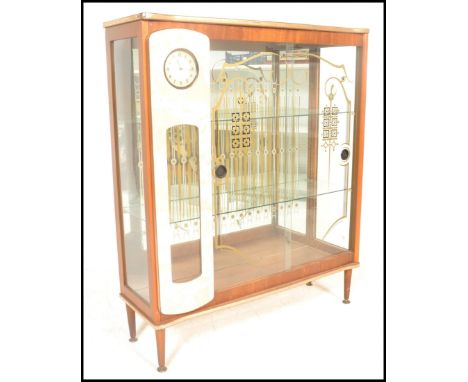 A vintage mid century retro glass fronted mirror back cocktail display cabinet with painted glass detailing, the cabinet fitt