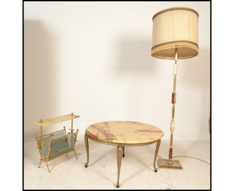A vintage 20th Century onyx topped circular coffee table, the flared top raised on a gilt metal base together with a matching