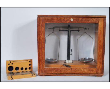 A vintage 20th Century cased&nbsp; set of Philip Harris Ltd scientific / apothecary / laboratory scales inside a glazed woode